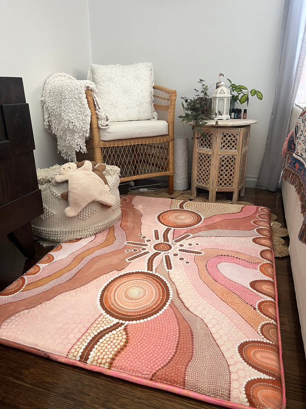 A soft rug situated on the living room floor, providing comfort and visual interest to the area.