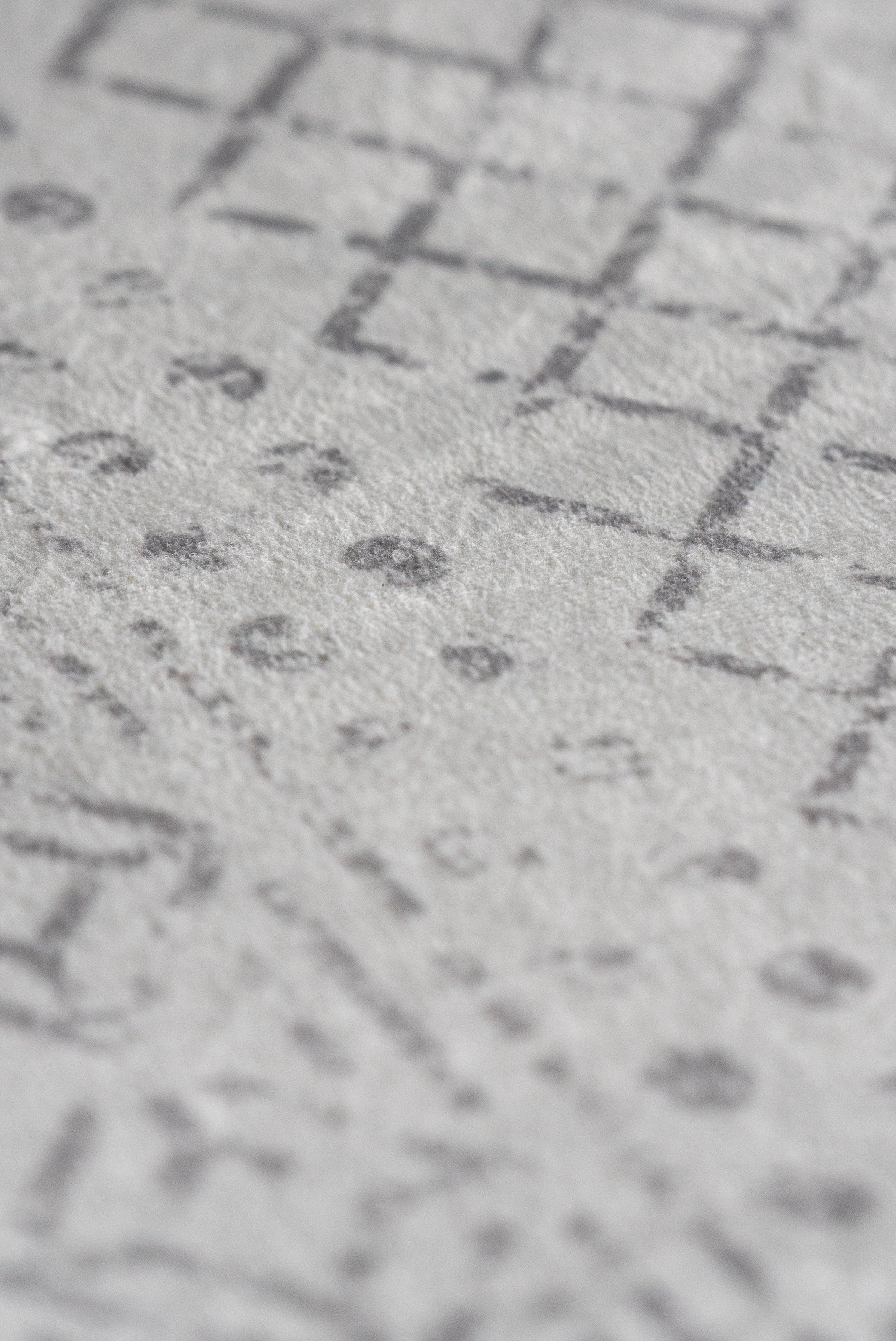 A geometric pattern in white and gray on wallpaper, offering a sleek and modern design for interior spaces.