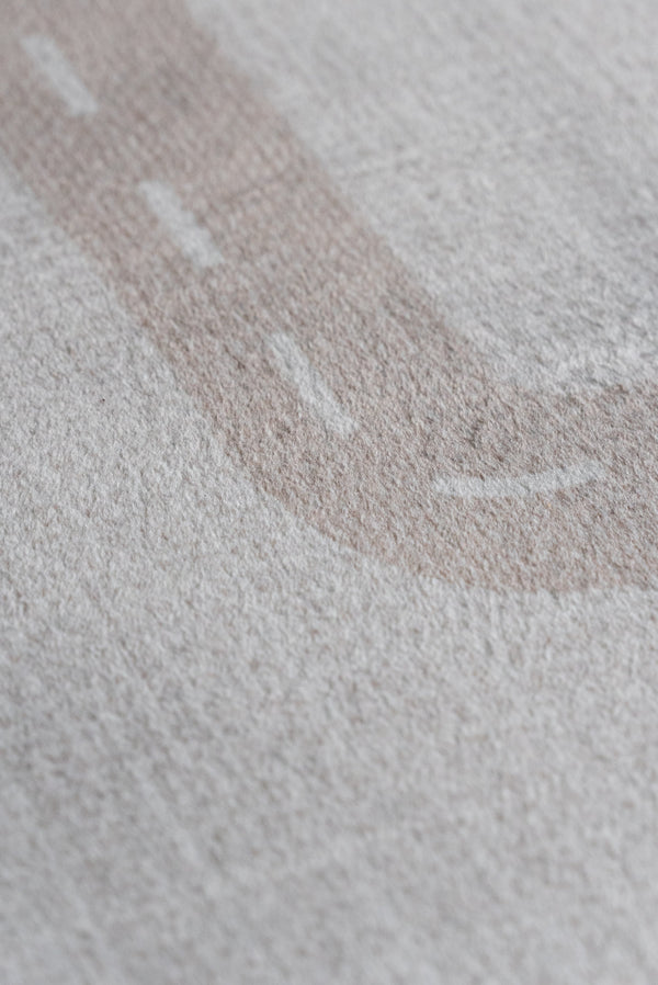 Close-up of a fabric featuring a detailed road design, showcasing textures and colors