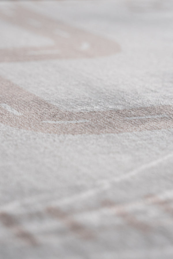 Detailed view of a white sheet with a faint white line, highlighting texture and simplicity.