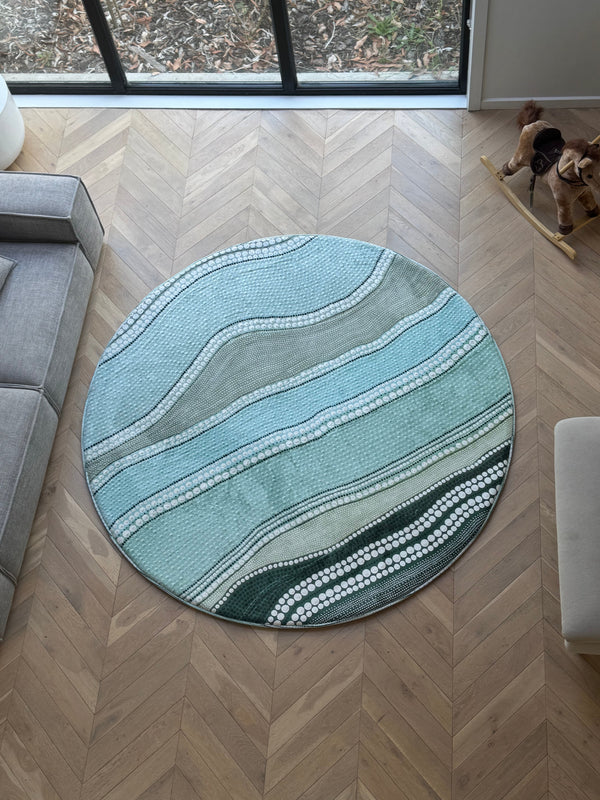 A round rug memory foam tatami with ocean reef artwork placed in a cozy living room setting.