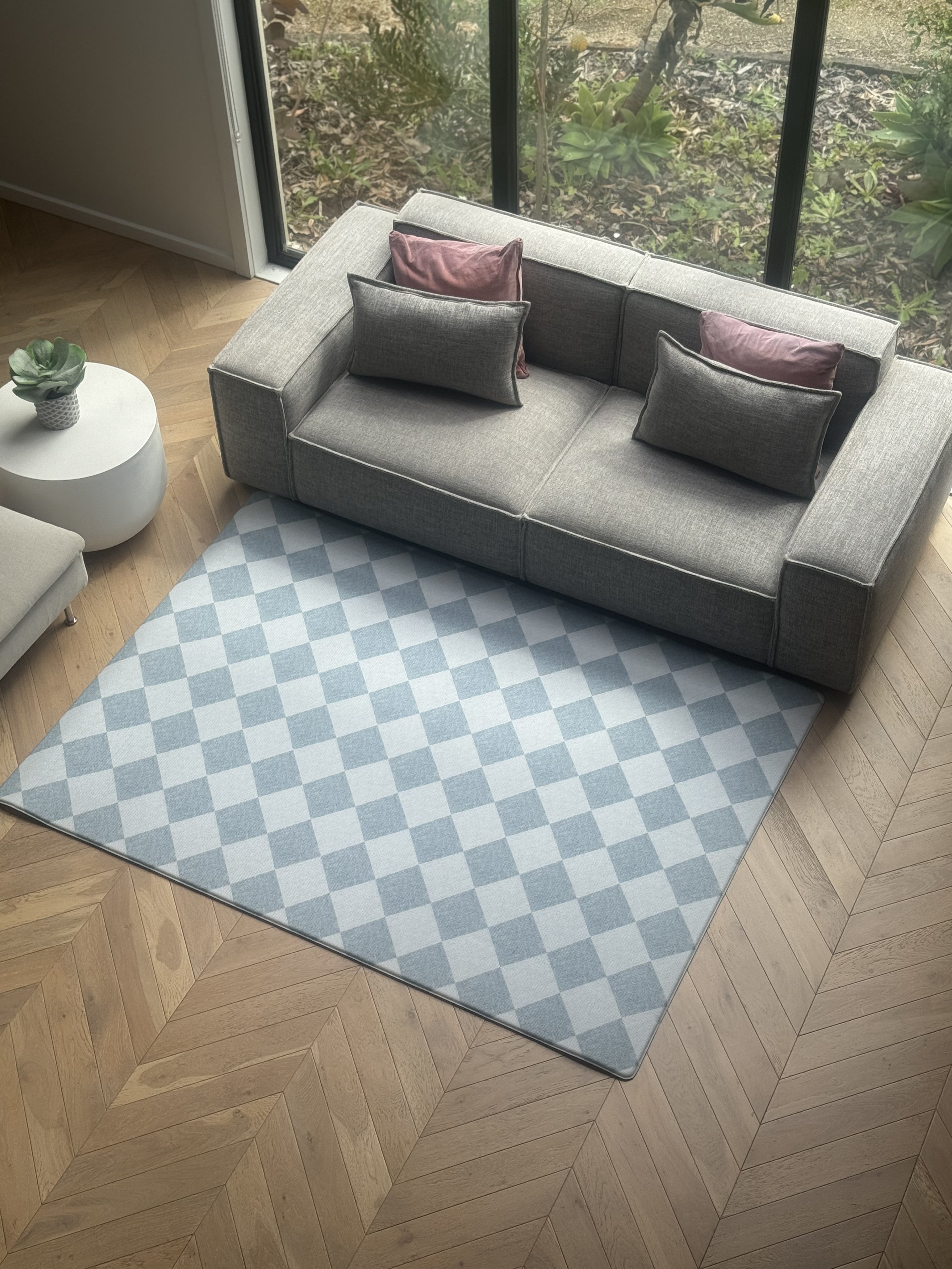 A blue and white checkered rug placed in a cozy living room setting.
