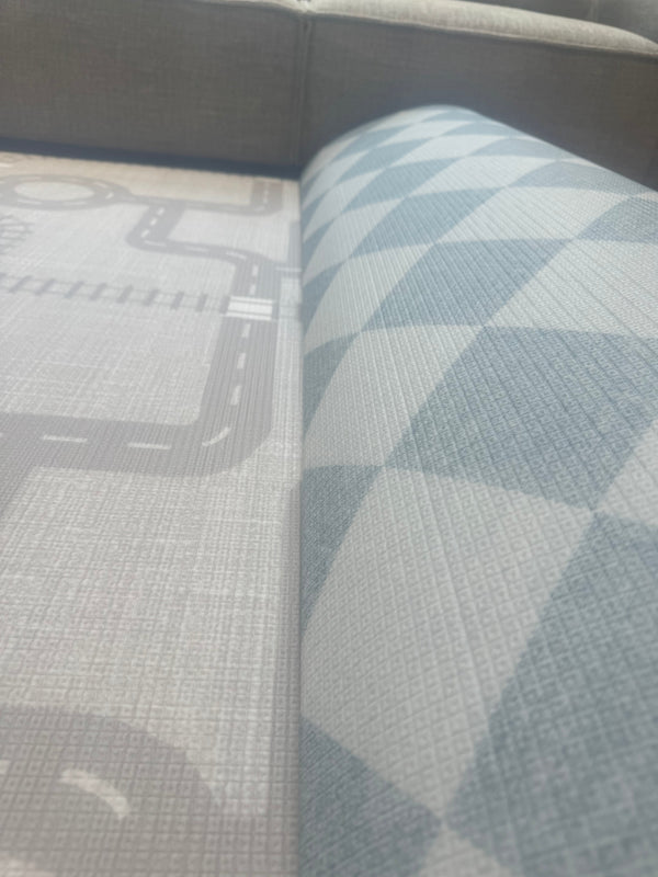 A blue and white checkered rug is displayed in a bright and inviting living room.