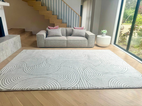 A living room showcasing a rug, a plush couch, and a fireplace, inviting relaxation and comfort.