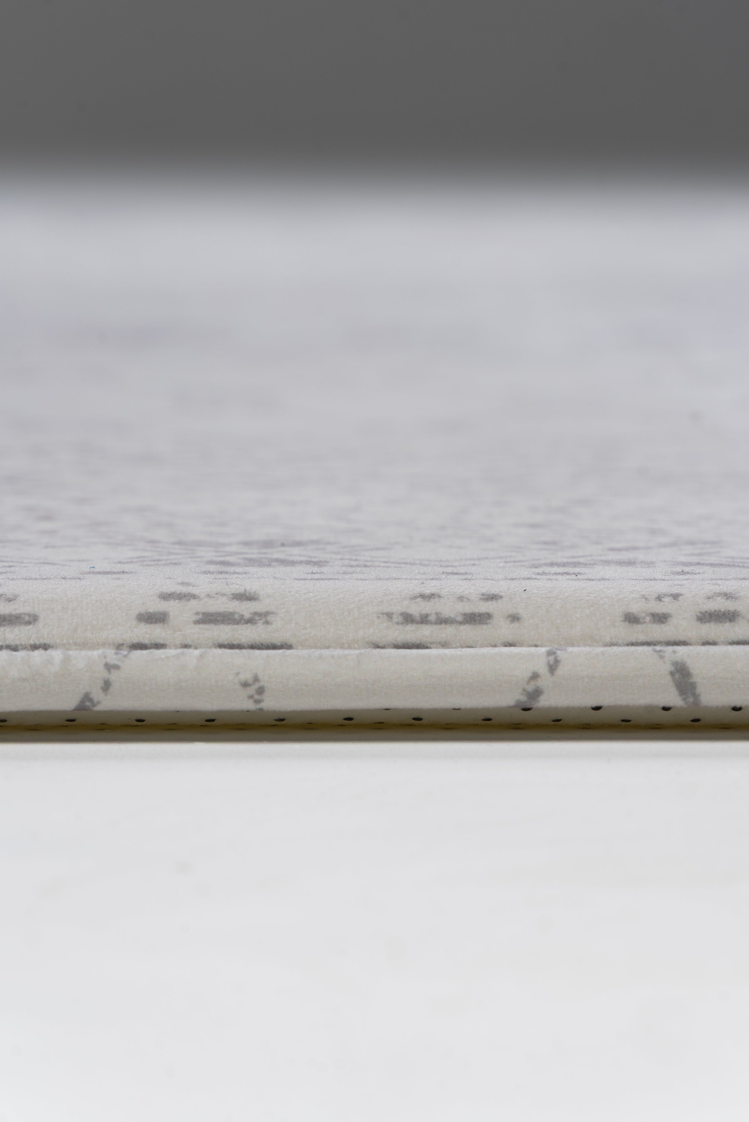 A white rug adorned with a geometric pattern, adding a contemporary touch to the room's decor.