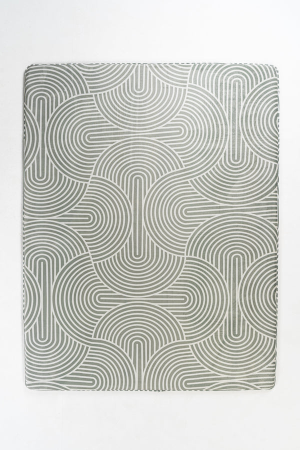 Gray rectangular placemat with a repeating pattern of concentric, arched lines.