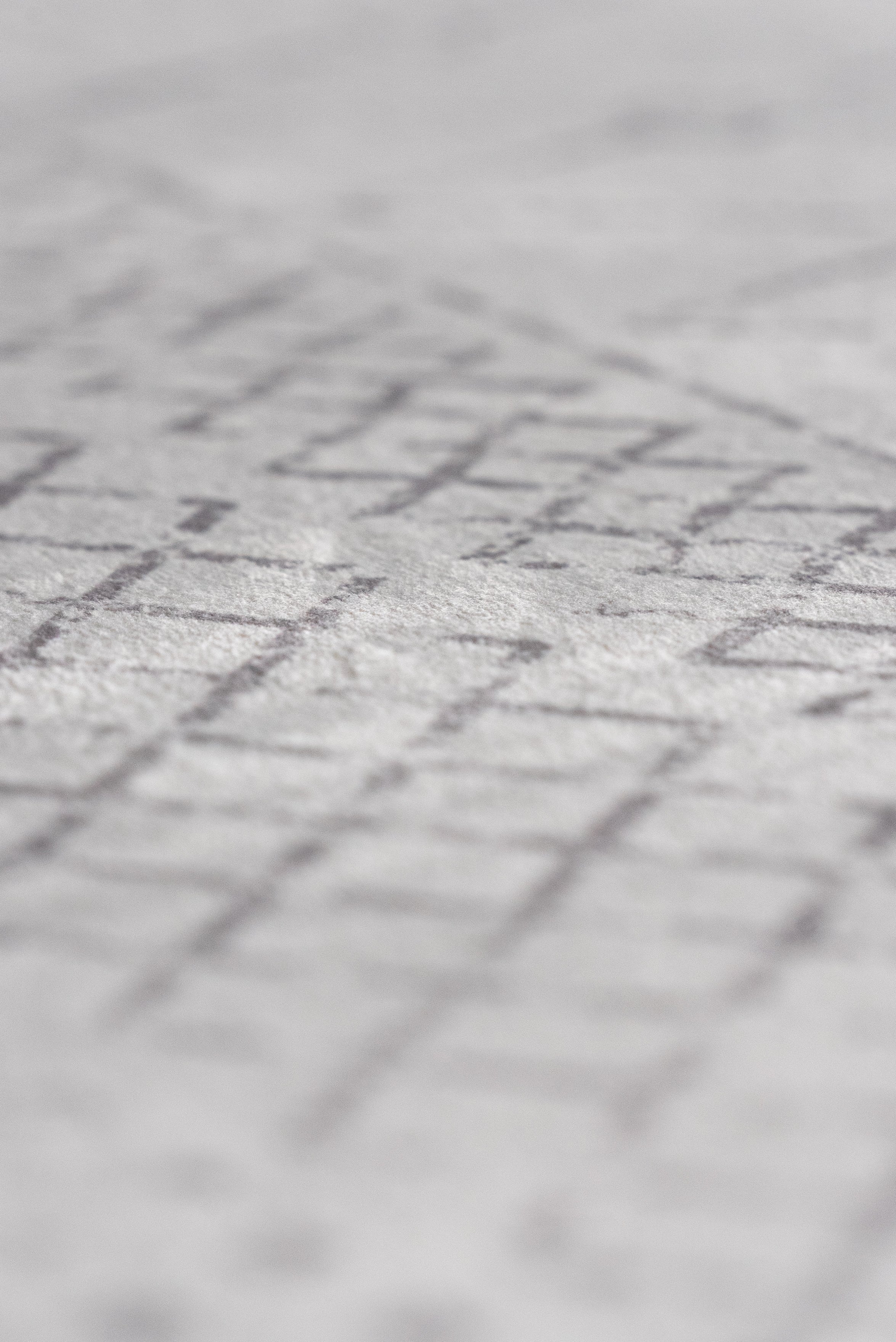 Boho rug with white and gray geometric pattern, adding a contemporary touch to any room's decor.