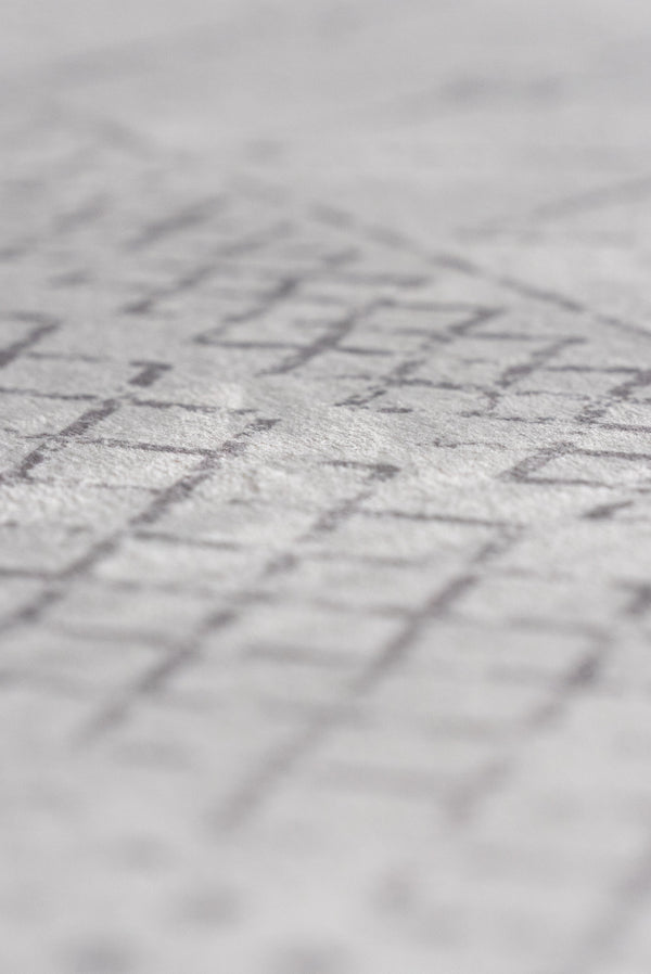 Boho rug with white and gray geometric pattern, adding a contemporary touch to any room's decor.